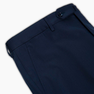 Close up of dark blue fine twill of 290 g yarn-dyed elasticised wool polyester chino style pants for man